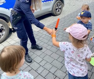 policjantka pokazująca latarkę dziecku