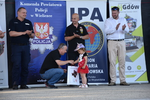 Najmłodszy uczestnik konkursu strzeleckiego otrzymuje prezent od Prezydenta IPA